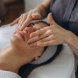 A beautiful woman enjoys a facial massage at a spa salon, indulging in skin and body care treatments. High quality photo